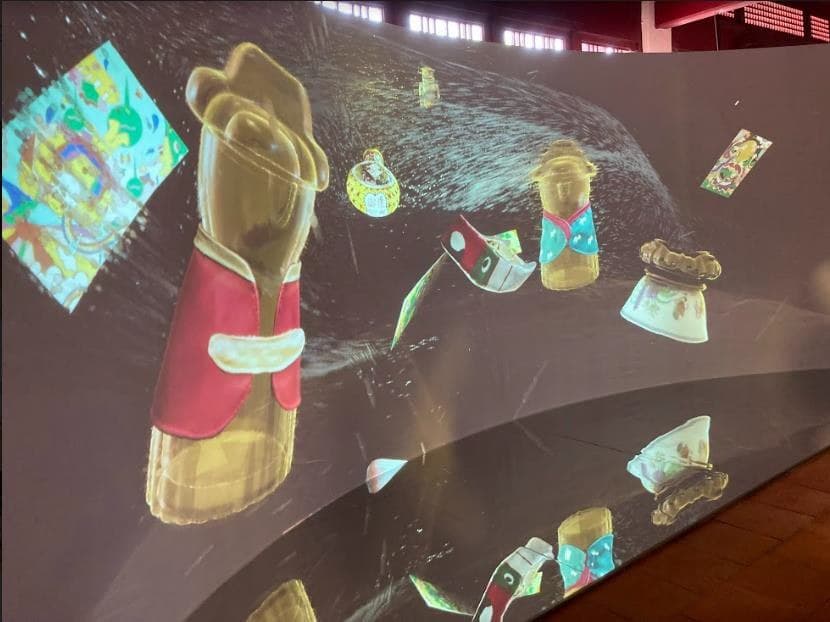 The immersive projection theatre: Palace Museum artefacts drifting across a curved wall and reflected in the polished floor